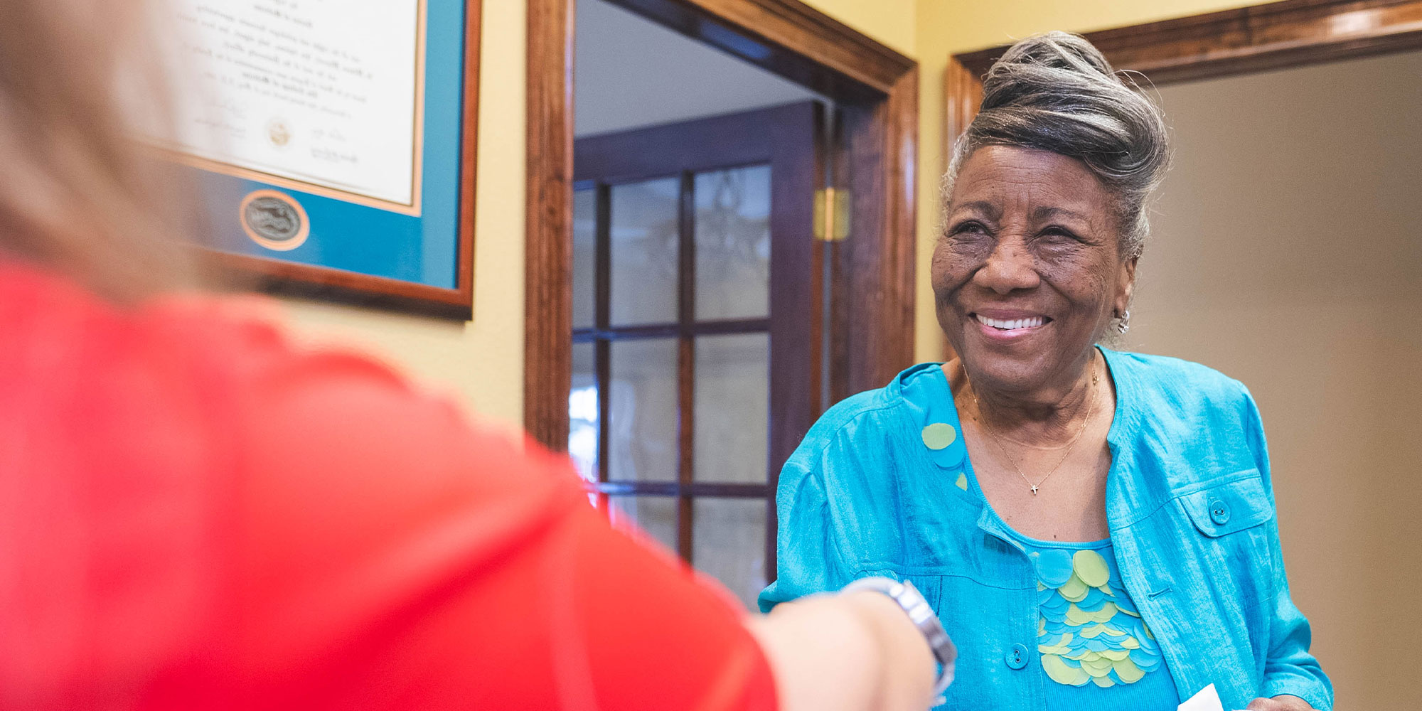 patient being helped at the front desk of the dental office