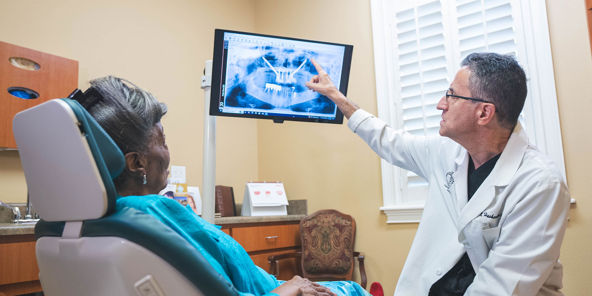 doctor showing dental patient treatment information