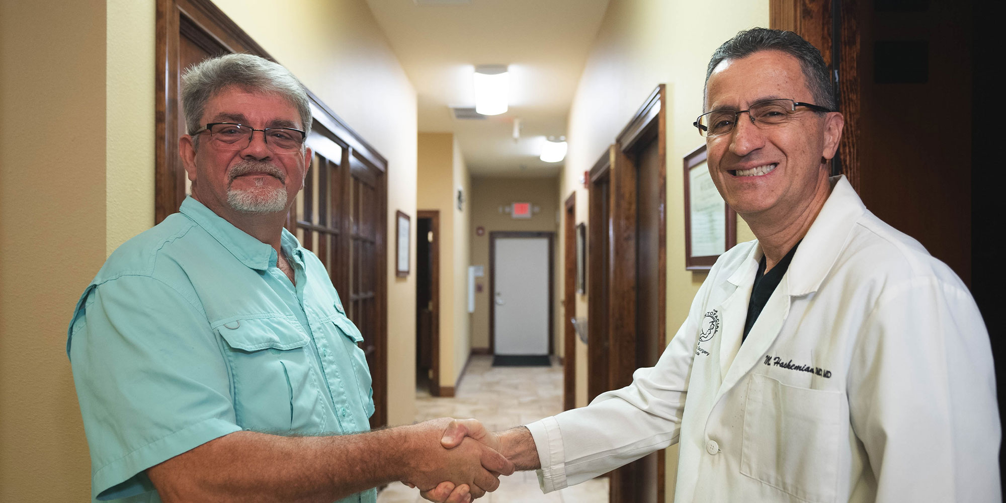 doctor and patient shaking hands after dental procedure