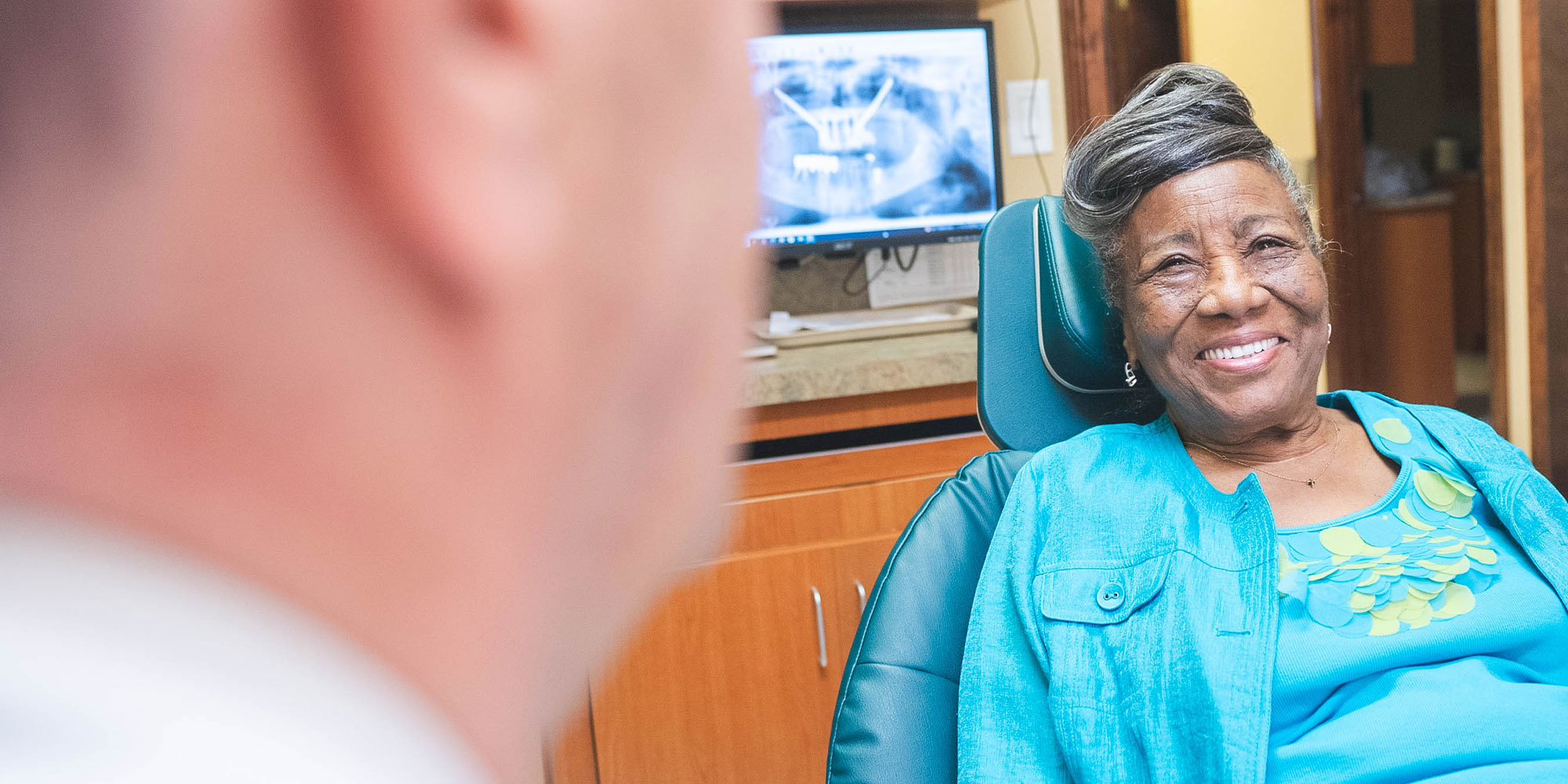 dental patient smiling brightly after their dental procedure within the dental center