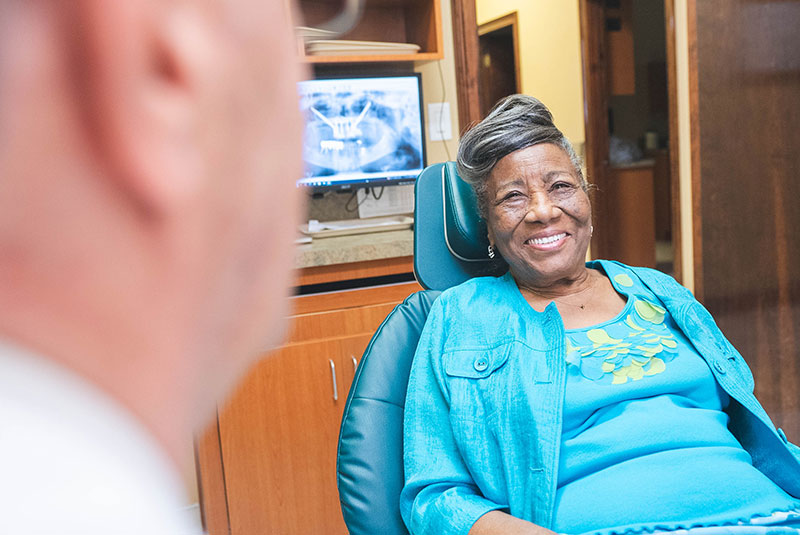 patient smiling brightly and prep and ready for dental treatment