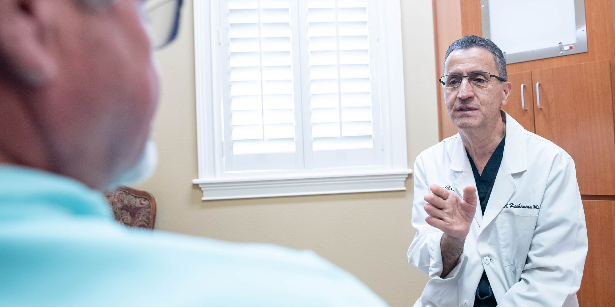 doctor going over dental procedure information with dental patient