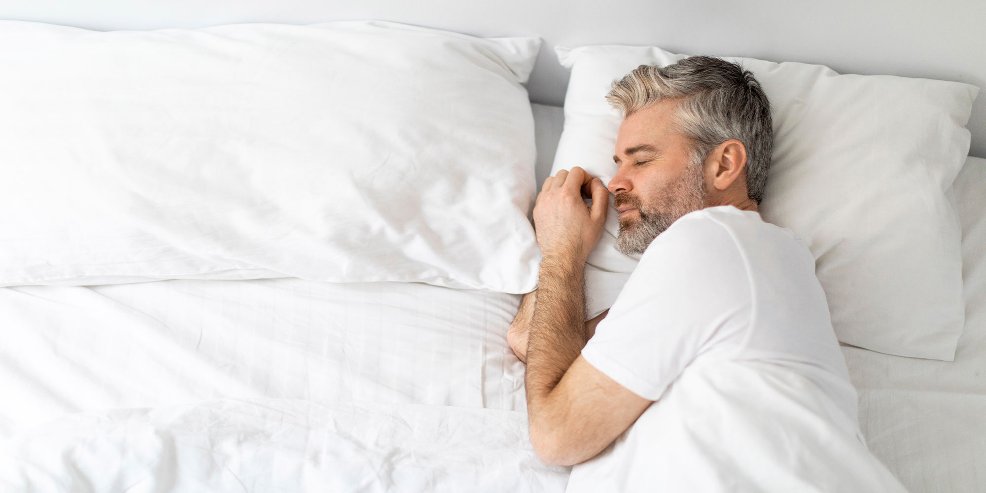 Top view of middle aged man sleeping in bed