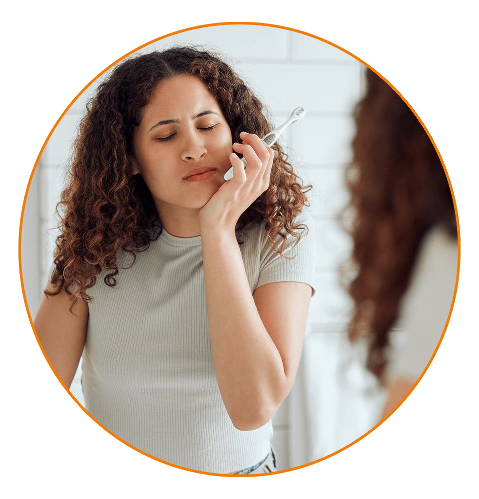 othache, oral pain and dental sensitivity for a woman brushing her teeth in the morning